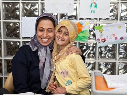 MAHAK child Taking photo with the head of MAHAK social worker