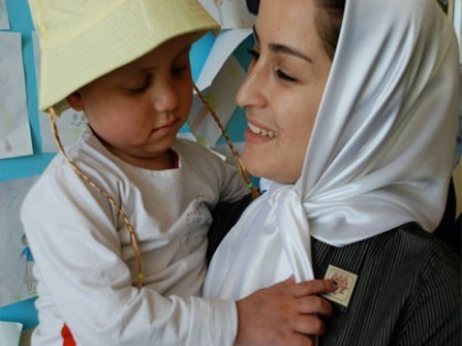 MAHAK social worker with one of MAHAK cancer-stricken children One of our social workers while talking and joking with Kosar