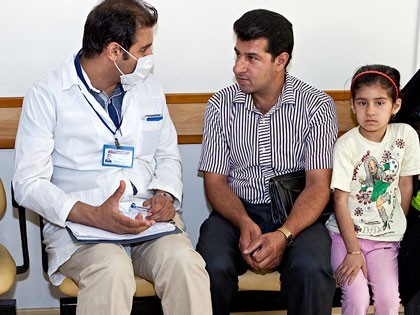 MAHAK psycologist with a child and her father One of MAHAK psychologist consulting with the father of cancer-stricken child referret to oncology clinic